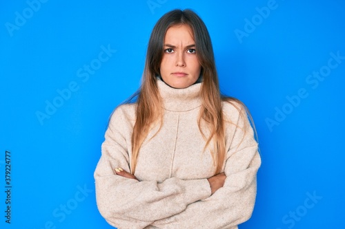Beautiful caucasian woman wearing wool winter sweater skeptic and nervous, disapproving expression on face with crossed arms. negative person. © Krakenimages.com