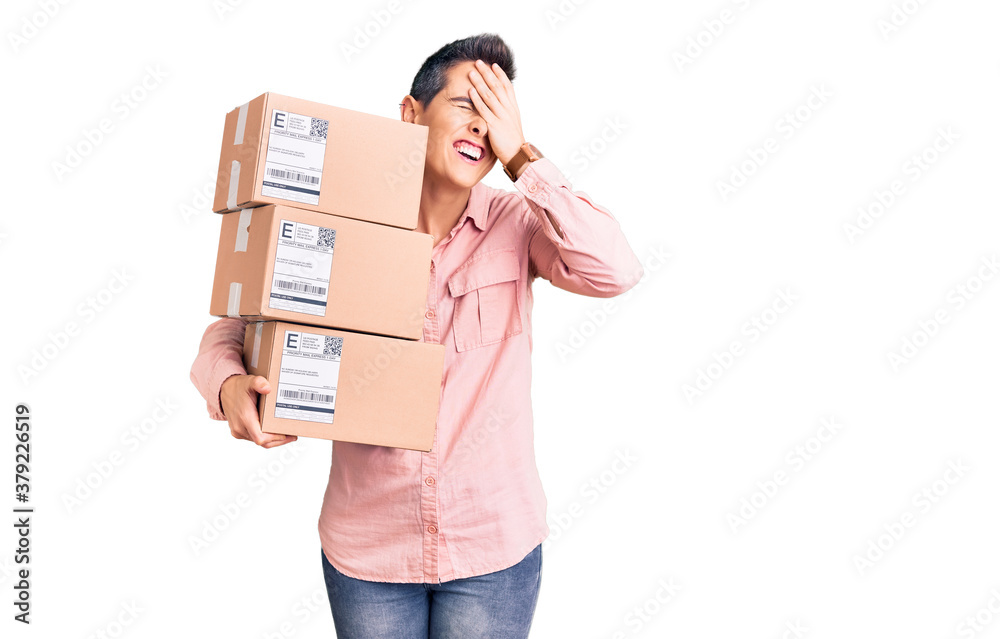 Young woman with short hair holding delivery package stressed and frustrated with hand on head, surprised and angry face Young woman with short hair holding delivery package stressed and frustrated with hand on head, surprised and angry face