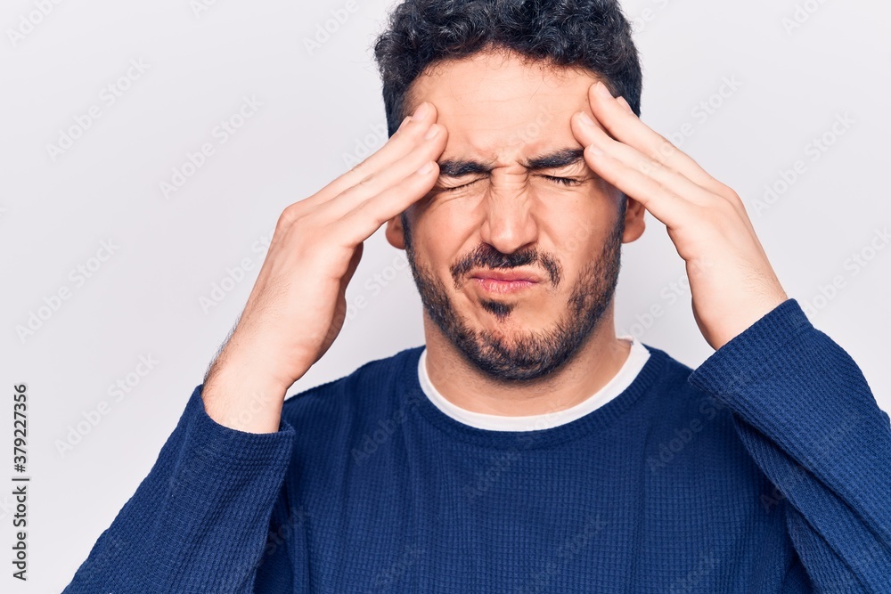 Young hispanic man wearing casual clothes with hand on head, headache because stress. suffering migraine. Young hispanic man wearing casual clothes with hand on head, headache because stress. suffering migraine.