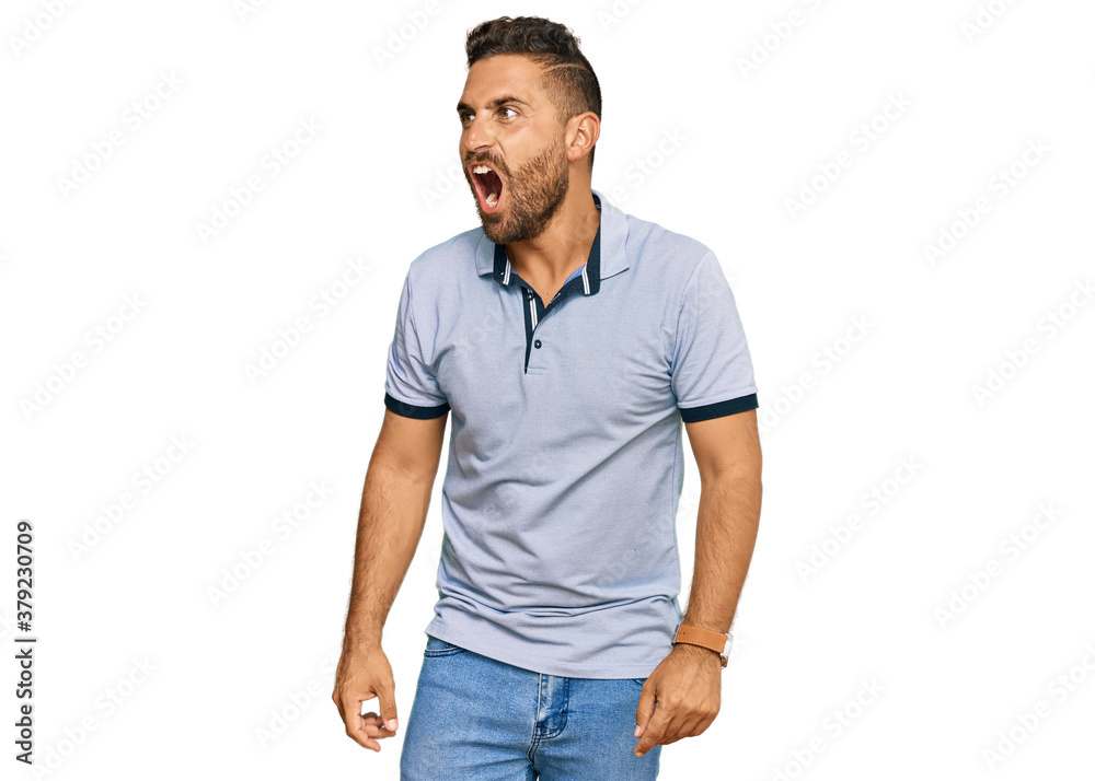 Handsome man with beard wearing casual clothes angry and mad screaming frustrated and furious, shouting with anger. rage and aggressive concept. Handsome man with beard wearing casual clothes angry and mad screaming frustrated and furious, shouting with anger. rage and aggressive concept.
