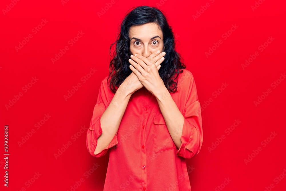 Young beautiful hispanic woman wearing casual clothes shocked covering mouth with hands for mistake. secret concept. Young beautiful hispanic woman wearing casual clothes shocked covering mouth with hands for mistake. secret concept.