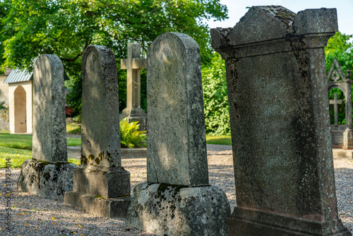 Row of large old tombstones at a cemetery in Sweden