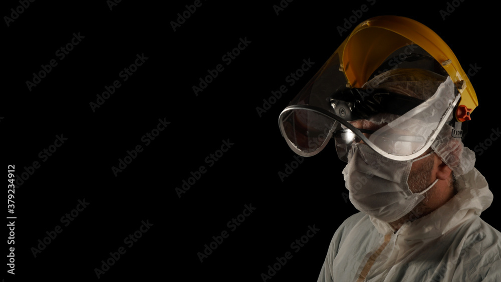 Health worker struggling with the covid-19 virus outbreak. on the dark background.
