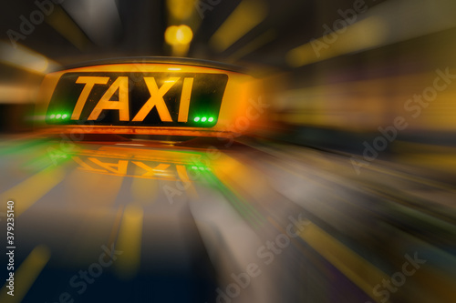 Orange taxi sign. Atmosphere of speed.