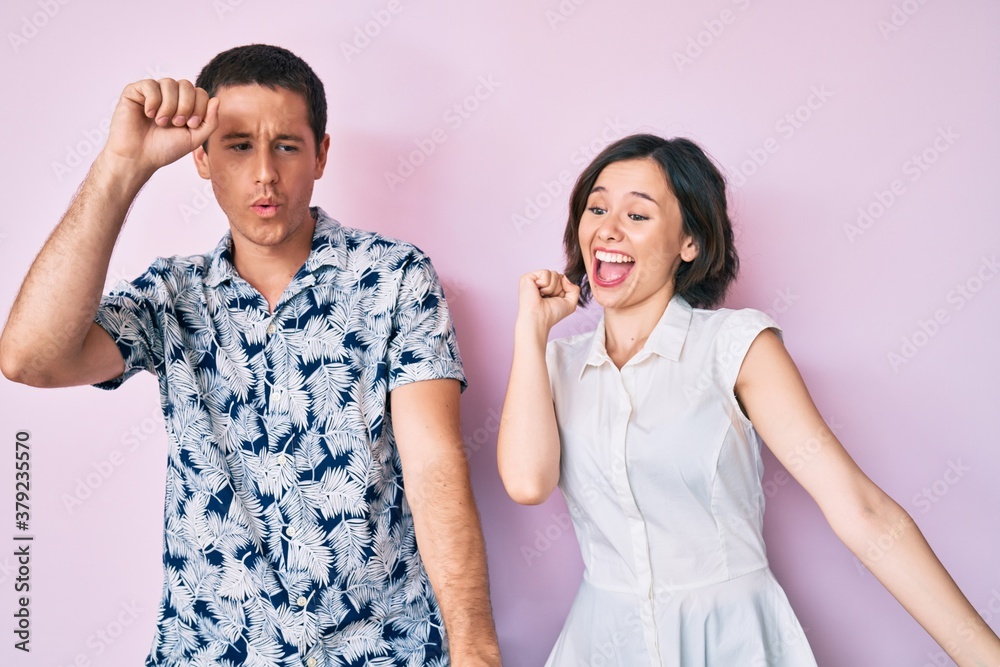 Beautiful couple wearing casual clothes dancing happy and cheerful, smiling moving casual and confident listening to music Beautiful couple wearing casual clothes dancing happy and cheerful, smiling moving casual and confident listening to music