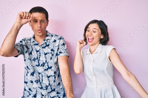 Beautiful couple wearing casual clothes dancing happy and cheerful, smiling moving casual and confident listening to music