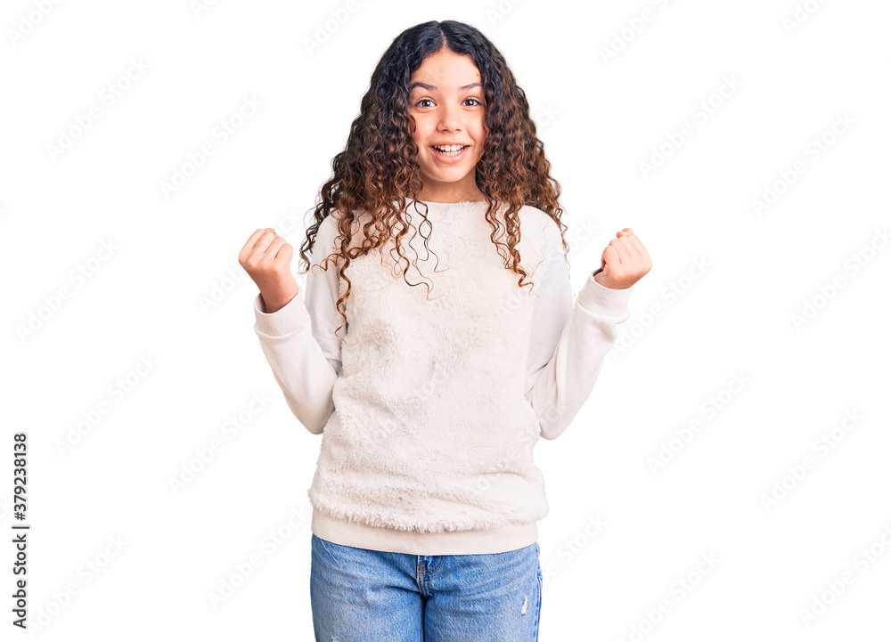 Beautiful kid girl with curly hair wearing casual clothes celebrating surprised and amazed for success with arms raised and open eyes. winner concept. Beautiful kid girl with curly hair wearing casual clothes celebrating surprised and amazed for success with arms raised and open eyes. winner concept.