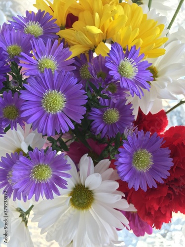 purple asters  yellow and white daisies and red carnations