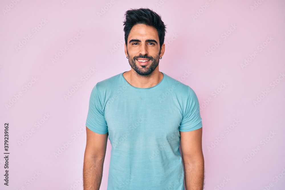 Handsome hispanic man with beard wearing casual clothes with a happy and cool smile on face. lucky person. Handsome hispanic man with beard wearing casual clothes with a happy and cool smile on face. lucky person.