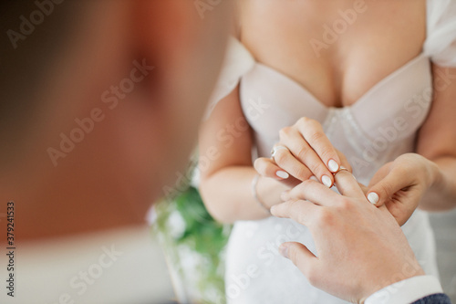 wedding, putting on a ring by the bride to the groom