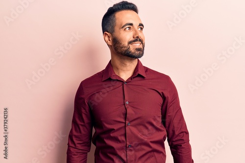Young hispanic man wearing casual clothes looking to side, relax profile pose with natural face and confident smile. © Krakenimages.com