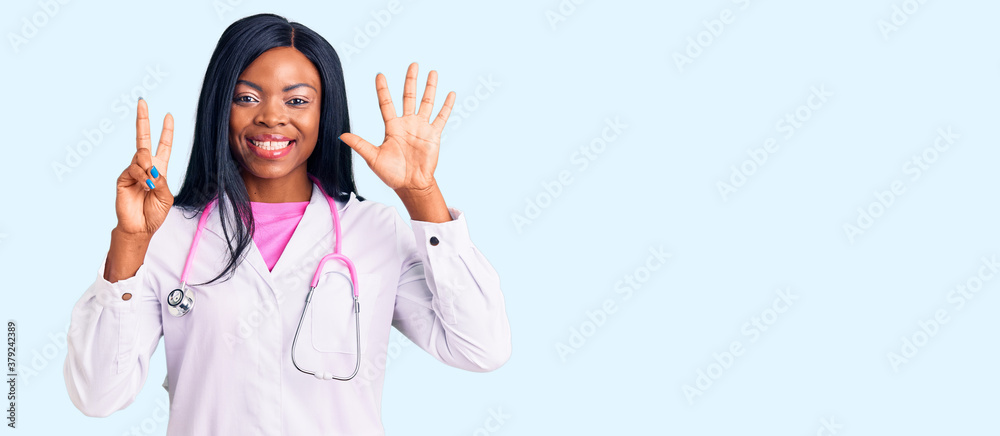 Young african american woman wearing doctor stethoscope showing and pointing up with fingers number seven while smiling confident and happy.