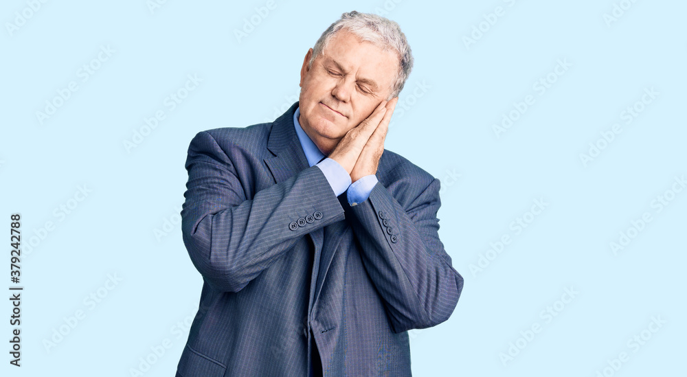 Senior grey-haired man wearing business jacket sleeping tired dreaming and posing with hands together while smiling with closed eyes. Senior grey-haired man wearing business jacket sleeping tired dreaming and posing with hands together while smiling with closed eyes.