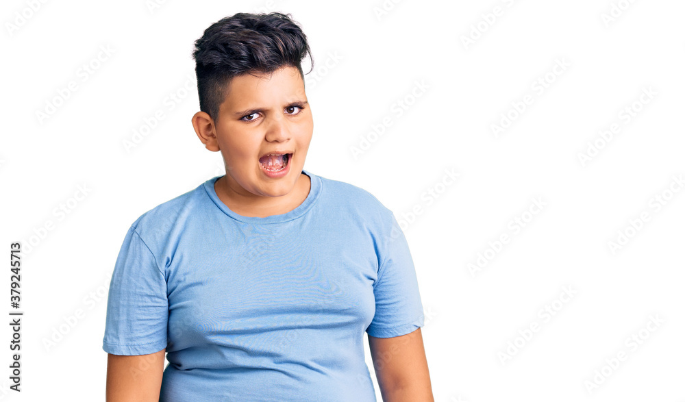 Little boy kid wearing sports workout clothes winking looking at the camera with sexy expression, cheerful and happy face. Little boy kid wearing sports workout clothes winking looking at the camera with sexy expression, cheerful and happy face.
