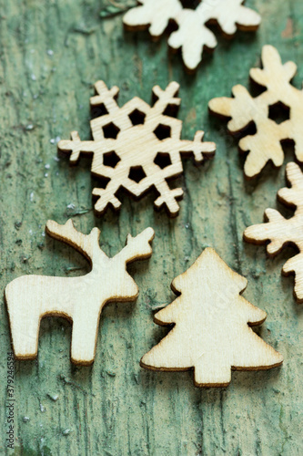 Christmas figurines made of wood on a wooden background.