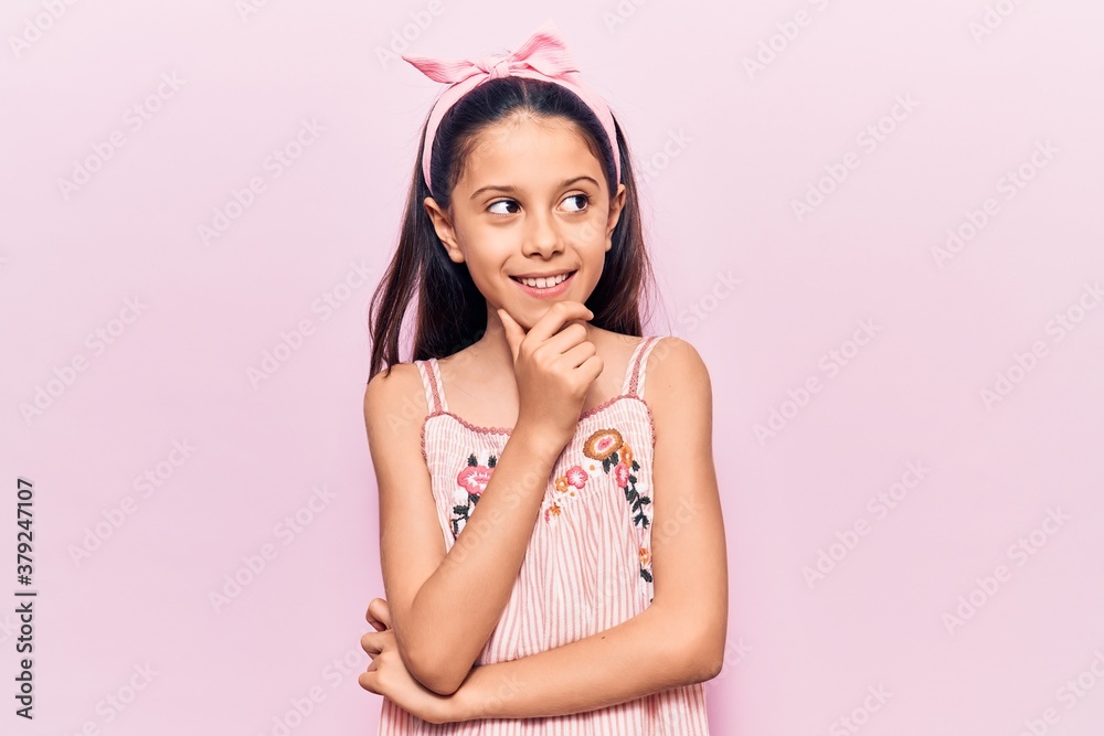 Beautiful child girl wearing casual clothes with hand on chin thinking about question, pensive expression. smiling with thoughtful face. doubt concept. Beautiful child girl wearing casual clothes with hand on chin thinking about question, pensive expression. smiling with thoughtful face. doubt concept.