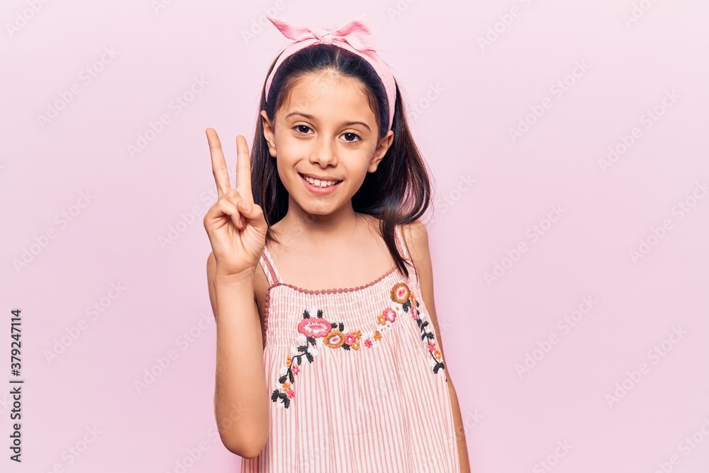 Beautiful child girl wearing casual clothes showing and pointing up with fingers number two while smiling confident and happy. Beautiful child girl wearing casual clothes showing and pointing up with fingers number two while smiling confident and happy.