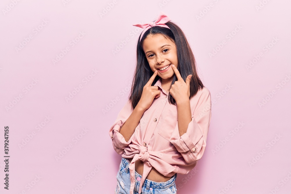 Beautiful child girl wearing casual clothes smiling with open mouth, fingers pointing and forcing cheerful smile Beautiful child girl wearing casual clothes smiling with open mouth, fingers pointing and forcing cheerful smile