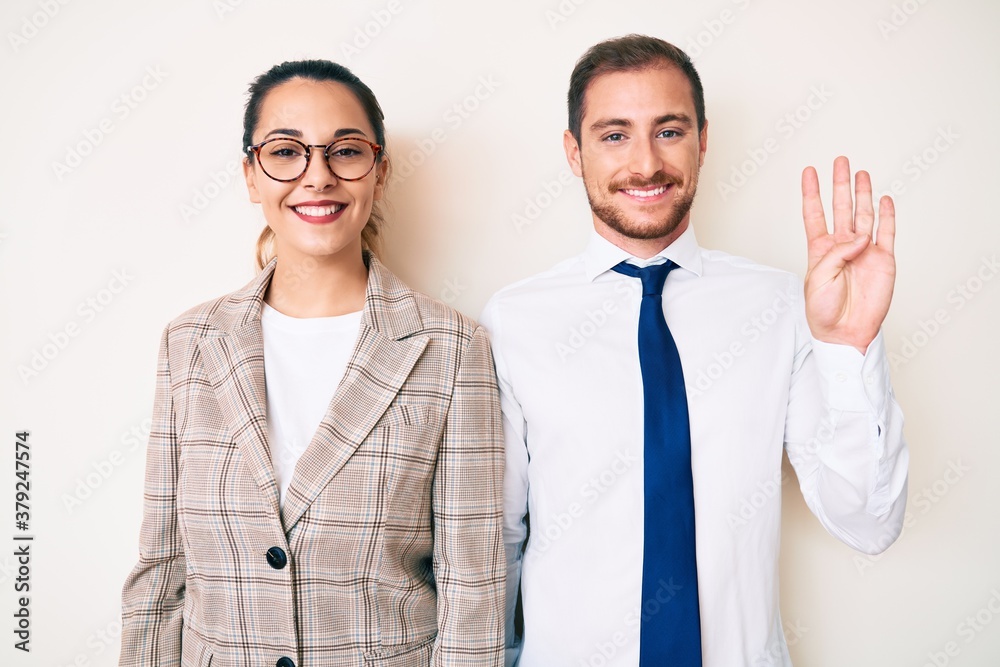Beautiful couple wearing business clothes showing and pointing up with fingers number four while smiling confident and happy. Beautiful couple wearing business clothes showing and pointing up with fingers number four while smiling confident and happy.