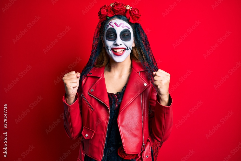 Woman wearing day of the dead costume over red celebrating surprised and amazed for success with arms raised and open eyes. winner concept. Woman wearing day of the dead costume over red celebrating surprised and amazed for success with arms raised and open eyes. winner concept.
