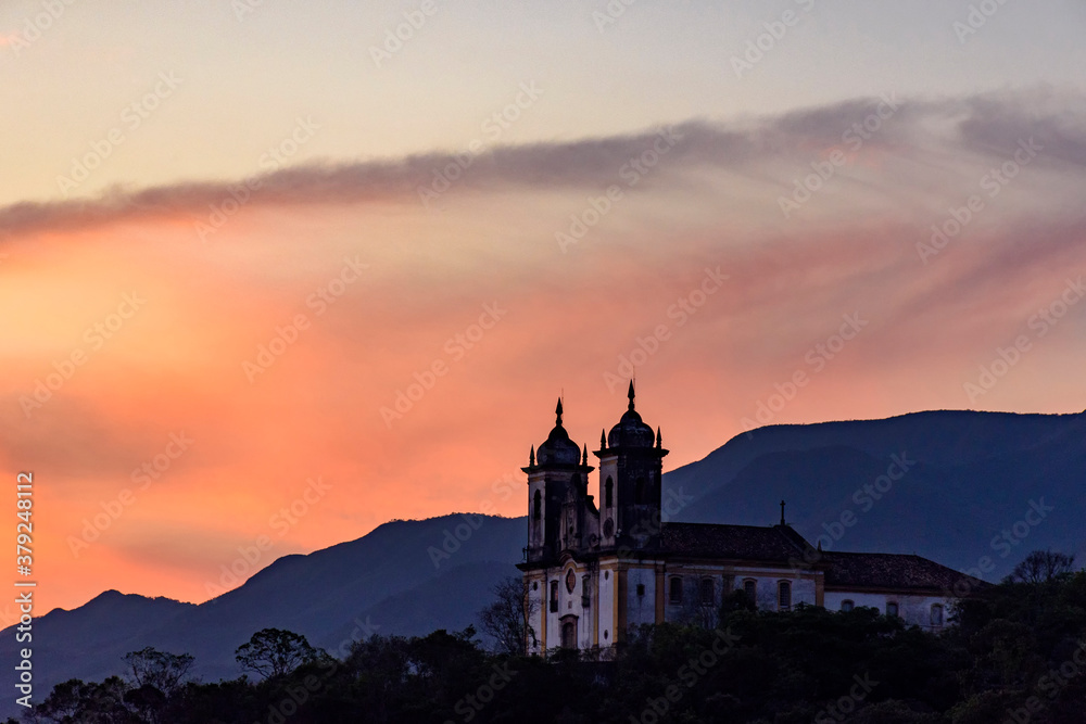 Old and historic 18th century church with its facade illuminated by sunset in the city of Ouro Preto, Minas Gerais, Brazil