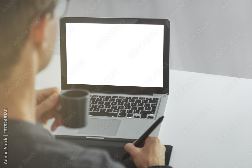 Man working from home using tablet for retouching photos. . Man working from home using tablet for retouching photos. .