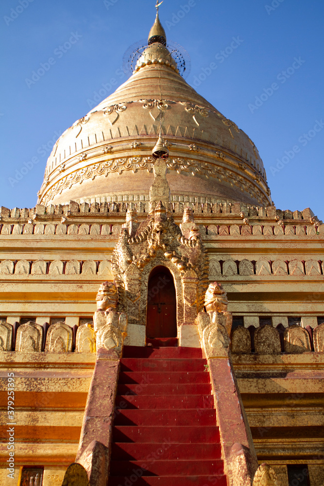 A gold plated pagoda in Myanmar shines in the midday sun.