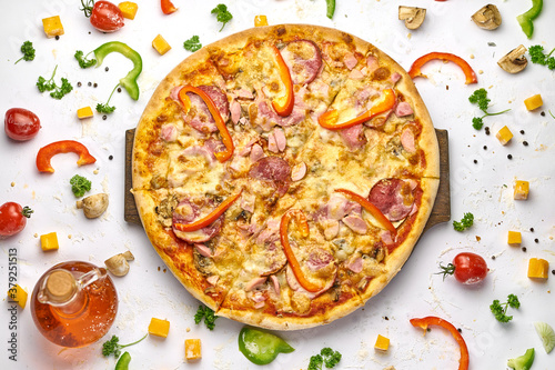 Delicious pizza with sausage, mushrooms, bell pepper on wooden plate