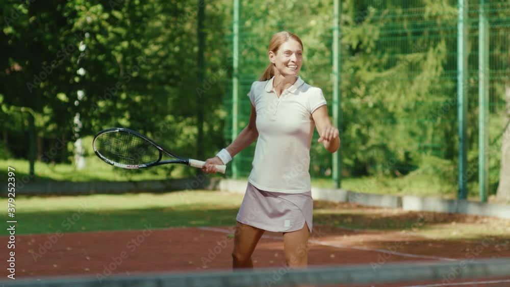 Close up young woman playing tennis outdoor court at sunlight tennis ball active adult sportswoman challenge player racket match activity athletic training slow motion Close up young woman playing tennis outdoor court at sunlight tennis ball active adult sportswoman challenge player racket match activity athletic training slow motion
