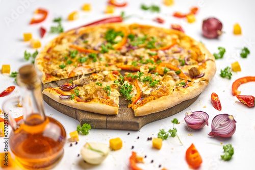 Pizza with chicken, mushrooms and sweet pepper on wooden plate