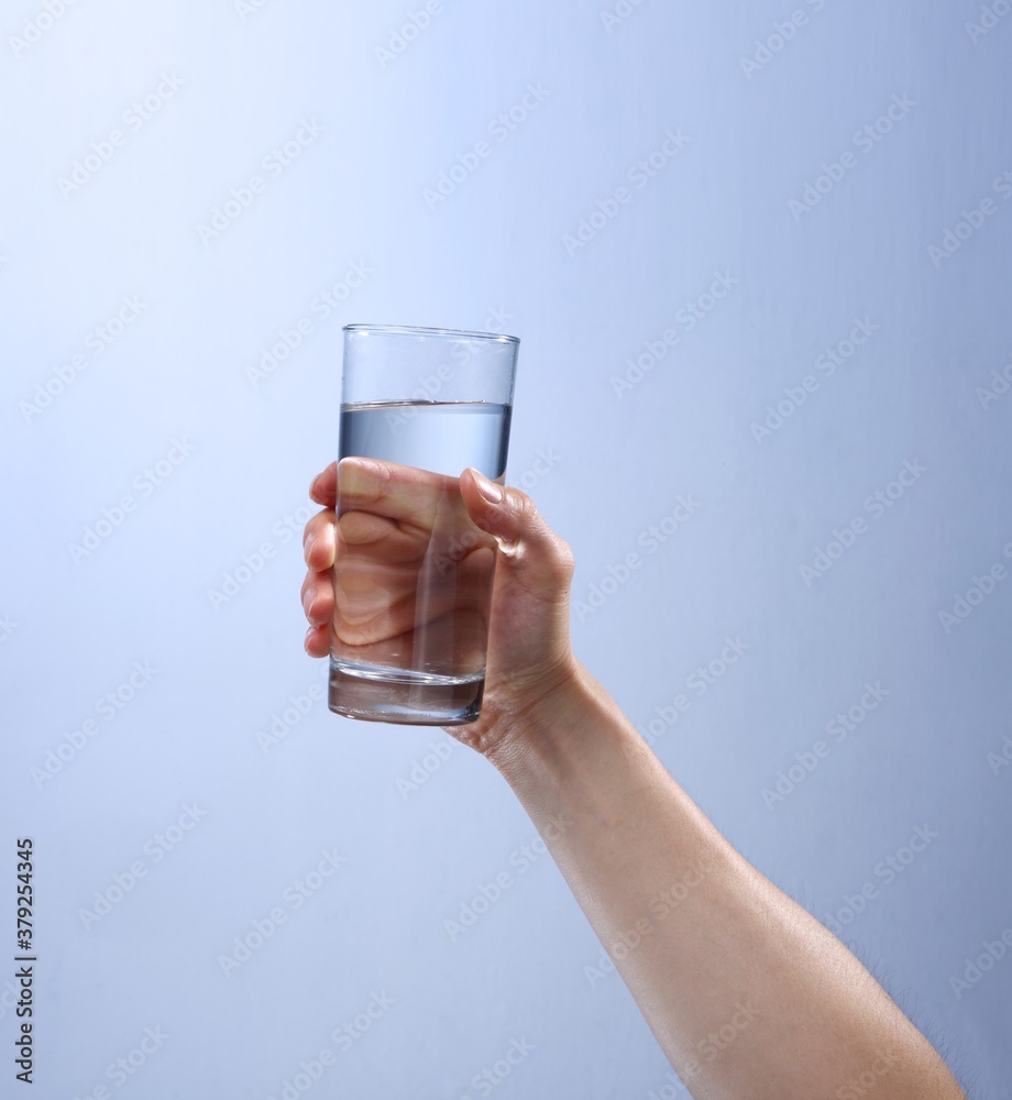 hand holding a glass of water hand holding a glass of water