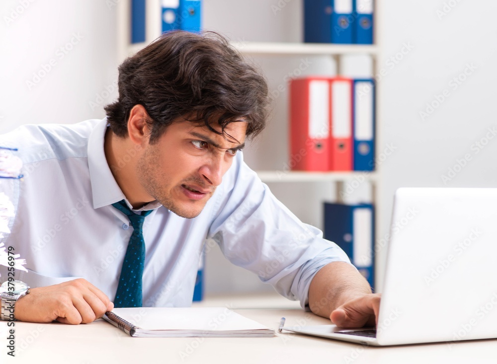 Overloaded busy employee with too much work and paperwork Overloaded busy employee with too much work and paperwork