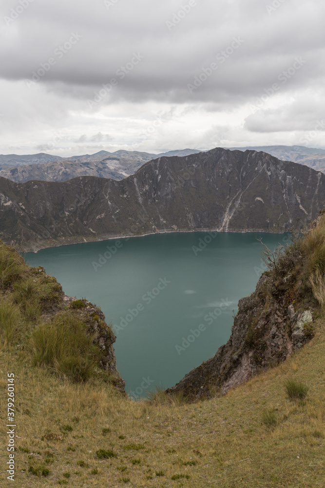 detail of a lake between the mountains and a cloudy sky in Ecuador, Quilotoa
