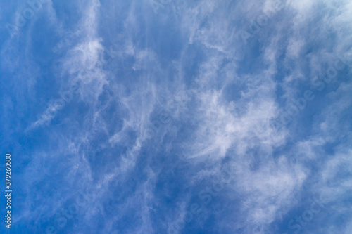 white cirrus clouds in the blue sky