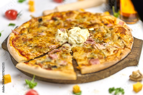 Delicious pizza with bacon, mushrooms, processed cheese on wooden plate