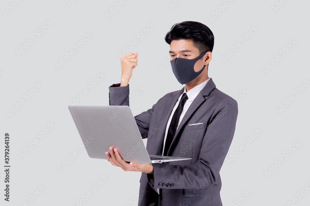 Young asian business man in face mask using laptop computer and success isolated on white background, quarantine and epidemic covid-19, businessman work from home, social distancing, new normal. Young asian business man in face mask using laptop computer and success isolated on white background, quarantine and epidemic covid-19, businessman work from home, social distancing, new normal.