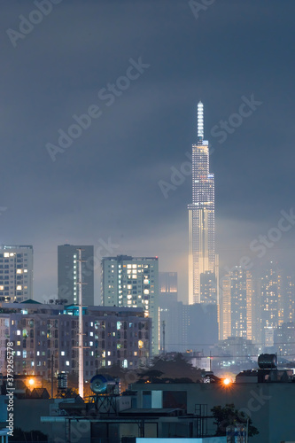 Spectacular view of a landmark 81 skyscraper sky in mist and clouds at Saigon at night in Ho chi minh city, Vietnam