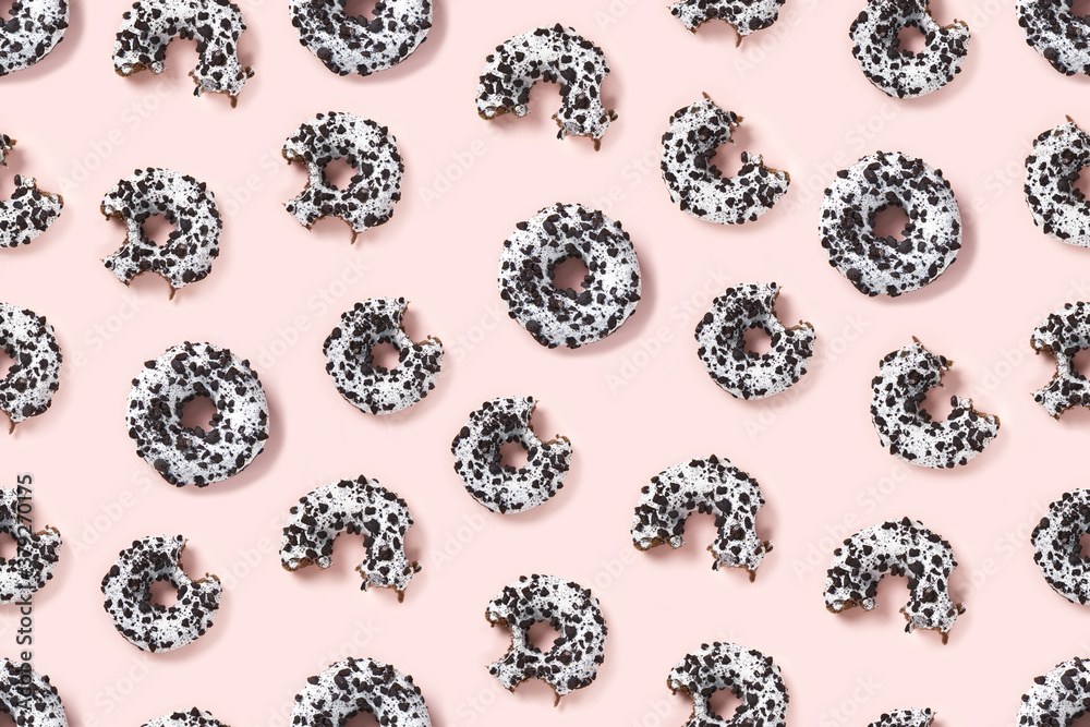 donuts on a pink background top view. Flat lay of delicious nibbled chocolate donuts. used as donut banner or poster background, seamless pattern. donuts on a pink background top view. Flat lay of delicious nibbled chocolate donuts. used as donut banner or poster background, seamless pattern.