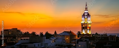 Wonderful view after sunset over Cartagena with illuminated Cartagena Cathedral against orange-yellow sky photo