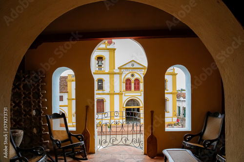 View from a room with open door and windows to a colonial church in Santa Cruz de Mompox, Colombia, World Heritage
 photo