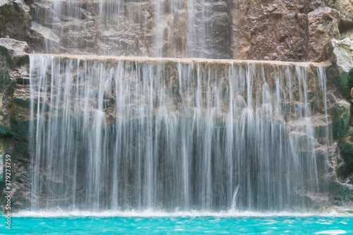 landscape of beautiful Artificial waterfall in garden at the public park