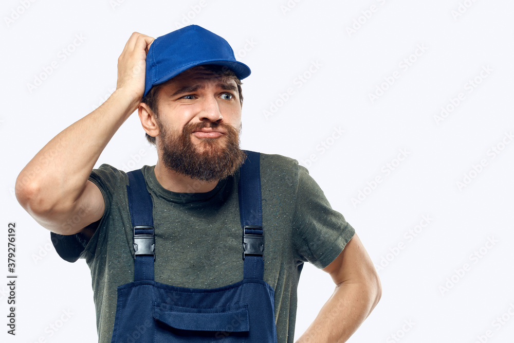 Worker man uniform delivery service emotions studio light background Worker man uniform delivery service emotions studio light background