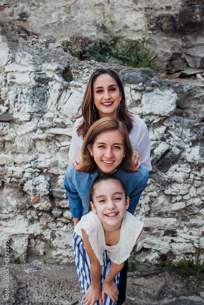 portrait of latin mother with her daughters in Mexico