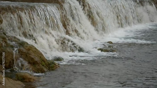 Catching a waterfall in a small freshwater channel. photo