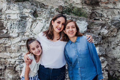portrait of hispanic mother with her daughters in Mexico