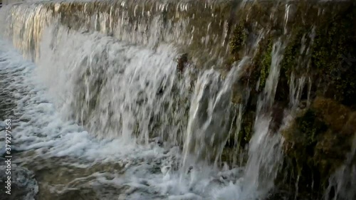 Catching a waterfall in a small freshwater channel. photo