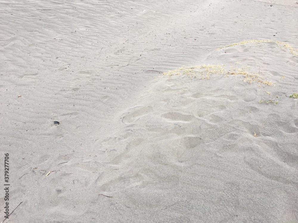 closeup of sand pattern of a beach in the summer closeup of sand pattern of a beach in the summer