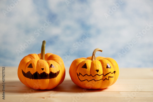 Halloween pumpkins with painted face on blue color background © shersor