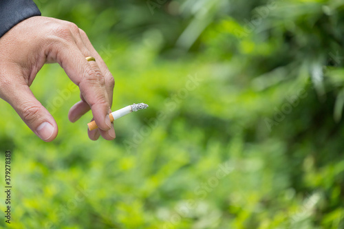 hand of man holding a cigarette