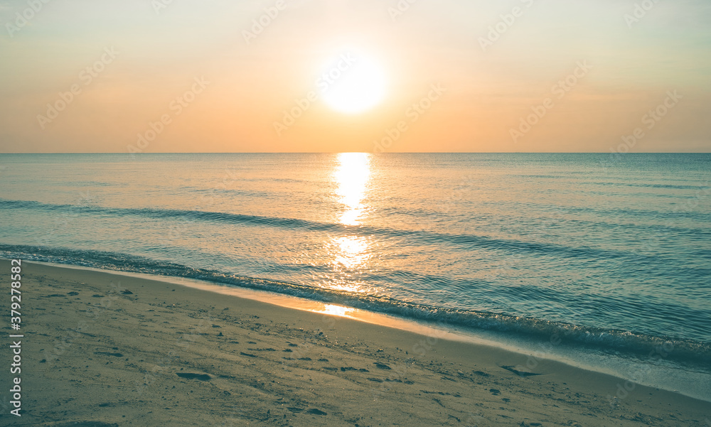 Beautiful golden sunset with blue sky over the horizon on the beach background, Thailand. Tropical twilight colorful sunrise from the landscape sea. Summer vacation concept.